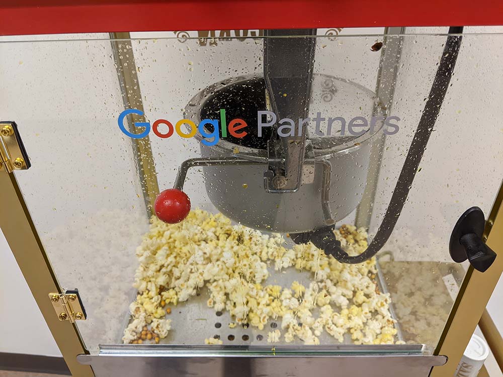 A picture of a google partners branded popcorn machine.