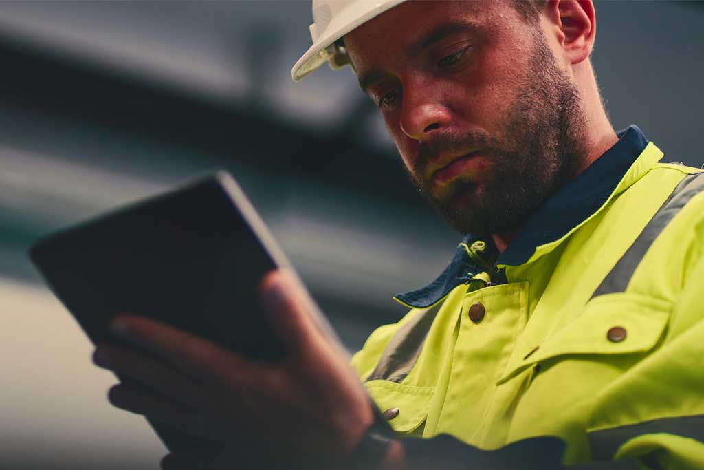 Email marketing - email marketing - construction worker reading email